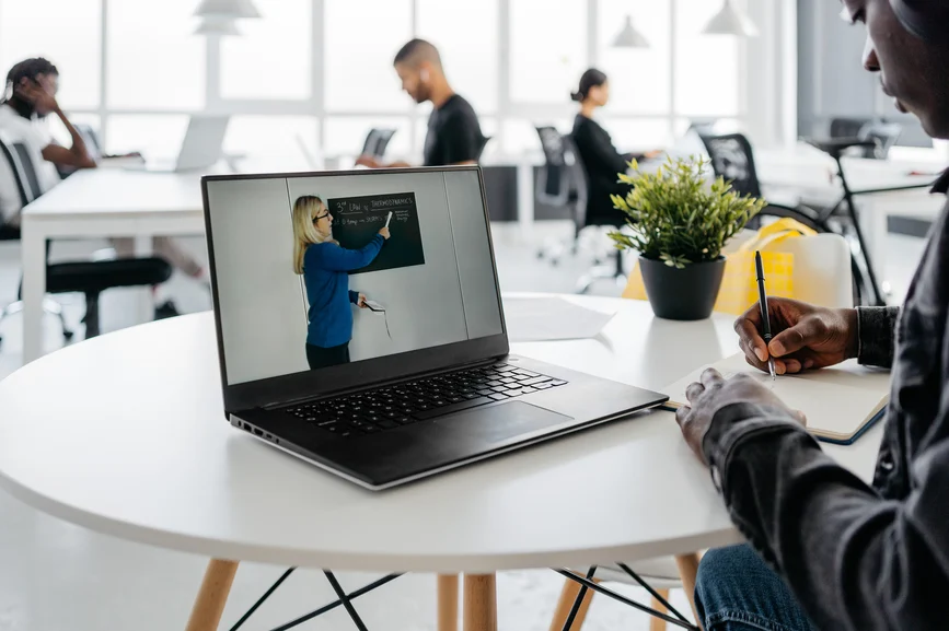 Student using an LMS platform on a laptop to access online classes and assignments
